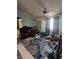 Spacious living room with a ceiling fan and natural light from the window at 4238 Rollingstone Dr, Las Vegas, NV 89103