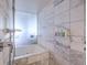 Modern bathroom featuring a soaking tub, premium fixtures and marble tile at 4381 W Flamingo Rd # 1905, Las Vegas, NV 89103