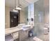 Elegant bathroom with dual sinks, marble countertops, and glass shower enclosure at 4381 W Flamingo Rd # 1905, Las Vegas, NV 89103