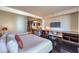 Modern bedroom features an integrated desk and seating area, and a partial view of a well-lit kitchen at 4381 W Flamingo Rd # 1905, Las Vegas, NV 89103