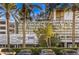 The Palms Place featuring well-maintained landscaping, palm trees, and building signage at 4381 W Flamingo Rd # 1905, Las Vegas, NV 89103