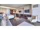 Spacious living area featuring a bed, sofa, entertainment center, and kitchenette at 4381 W Flamingo Rd # 1905, Las Vegas, NV 89103