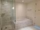 Bathroom with separate tiled shower and soaking tub, and marble-look tile at 4471 Dean Martin Dr # 1104, Las Vegas, NV 89103