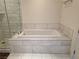 Bathroom with separate tiled shower and soaking tub, and marble-look tile at 4471 Dean Martin Dr # 1104, Las Vegas, NV 89103