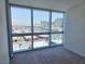 This bedroom features floor to ceiling windows with city views and neutral carpeting at 4471 Dean Martin Dr # 1104, Las Vegas, NV 89103
