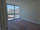 This bedroom features floor to ceiling windows with city views and neutral carpeting at 4471 Dean Martin Dr # 1104, Las Vegas, NV 89103