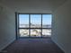 This bedroom features floor to ceiling windows with city views and neutral carpeting at 4471 Dean Martin Dr # 1104, Las Vegas, NV 89103