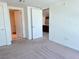 Bright bedroom showcasing neutral carpet, white walls, and access to kitchen and bathroom at 4471 Dean Martin Dr # 1104, Las Vegas, NV 89103
