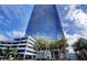 The Martin high rise building exterior with palm trees and blue glass window facade at 4471 Dean Martin Dr # 1104, Las Vegas, NV 89103