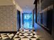 Hallway with black and white patterned walls and floors leads to a door with an exit sign at 4471 Dean Martin Dr # 1104, Las Vegas, NV 89103