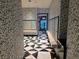 Hallway with black and white patterned walls and floors leads to mailboxes and vending machines at 4471 Dean Martin Dr # 1104, Las Vegas, NV 89103