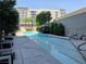 Swimming pool surrounded by trees and the exterior of the building at 4471 Dean Martin Dr # 1104, Las Vegas, NV 89103