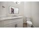 Clean powder room features a modern vanity with black hardware and a rectangular mirror at 4664 Stuttgart St, Las Vegas, NV 89147