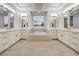 Bathroom featuring dual vanities, tile floors, and soaking tub at 4664 Stuttgart St, Las Vegas, NV 89147