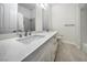 This bathroom features a double sink vanity, a large mirror, and is tiled for a clean and modern look at 4664 Stuttgart St, Las Vegas, NV 89147