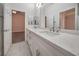 This bathroom features a double sink vanity, and a large mirror and doorway to the bedroom for convenience at 4664 Stuttgart St, Las Vegas, NV 89147