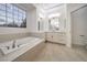 Bright bathroom featuring a soaking tub and vanity at 4664 Stuttgart St, Las Vegas, NV 89147