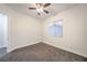 This bedroom features neutral walls, carpeted floors, a window, and a ceiling fan for optimal comfort at 4664 Stuttgart St, Las Vegas, NV 89147
