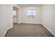 Cozy bedroom features carpet flooring, a window, and neutral paint at 4664 Stuttgart St, Las Vegas, NV 89147