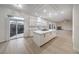 Bright kitchen featuring a large island, white cabinetry and easy access to backyard via sliding doors at 4664 Stuttgart St, Las Vegas, NV 89147
