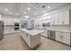 Spacious kitchen featuring white cabinetry, stainless steel appliances, and island cooktop at 4664 Stuttgart St, Las Vegas, NV 89147