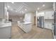 Modern kitchen features white cabinets, stainless steel appliances, and a large island cooktop at 4664 Stuttgart St, Las Vegas, NV 89147