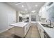 Modern kitchen features white cabinetry, large island and stainless steel appliances at 4664 Stuttgart St, Las Vegas, NV 89147