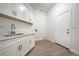 The laundry room features white cabinets, ample counter space and a convenient door to the outside at 4664 Stuttgart St, Las Vegas, NV 89147