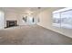 Large carpeted living area with fireplace, and several windows offering an abundance of natural light at 4664 Stuttgart St, Las Vegas, NV 89147