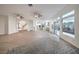 Spacious, open-concept living area with wood floors, a large rug, and plenty of natural light at 4664 Stuttgart St, Las Vegas, NV 89147