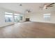 Bright living room boasts wood floors, fireplace, ceiling fans, and multiple windows at 4664 Stuttgart St, Las Vegas, NV 89147