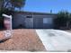 Exterior view of home with gravel yard, concrete driveway, and sign indicating a pool and casita at 5178 Wilbur St, Las Vegas, NV 89119