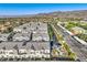 Wide aerial shot displays attractive townhomes featuring desert landscaping with ample parking and mountain view at 545 Thea St # 1315, Henderson, NV 89052