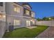 Townhome backyard with artificial turf, patio, and privacy fence at 545 Thea St # 1315, Henderson, NV 89052