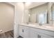 This bathroom features double sinks and white cabinets at 545 Thea St # 1315, Henderson, NV 89052