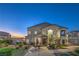 Inviting home exterior featuring a charming covered porch, meticulous landscaping, and warm exterior lighting at 545 Thea St # 1315, Henderson, NV 89052