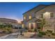 Townhome exterior featuring stone accents and landscaping at 545 Thea St # 1315, Henderson, NV 89052