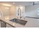 Bright, open kitchen with quartz countertops and a stainless steel sink and faucet at 545 Thea St # 1315, Henderson, NV 89052