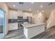 Stylish kitchen with stainless steel appliances, island, and modern backsplash at 545 Thea St # 1315, Henderson, NV 89052