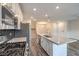 Gourmet kitchen with stainless appliances, center island, open to dining and living spaces at 545 Thea St # 1315, Henderson, NV 89052