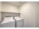 This laundry room includes a washing machine, dryer, and shelving at 545 Thea St # 1315, Henderson, NV 89052
