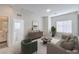 Comfortable living room with neutral tones, a large window, and inviting furniture at 545 Thea St # 1315, Henderson, NV 89052