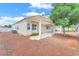 A backyard featuring a covered patio, xeriscaping, and mature trees at 5505 Verbena Creek Ct, Las Vegas, NV 89131