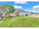 Spacious backyard showcases a well-manicured lawn, mature trees, and covered patio for outdoor enjoyment at 5505 Verbena Creek Ct, Las Vegas, NV 89131