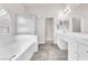 Bright bathroom featuring tub, glass shower, double vanity, and tile flooring at 5505 Verbena Creek Ct, Las Vegas, NV 89131