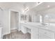 Bright bathroom featuring double vanity, tub, glass shower, and a large mirror at 5505 Verbena Creek Ct, Las Vegas, NV 89131