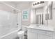 Bathroom with white tiles, a shower-tub combo, and white sink at 5505 Verbena Creek Ct, Las Vegas, NV 89131