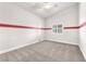 This is a bedroom with neutral carpet, white walls, a ceiling fan, and a window at 5505 Verbena Creek Ct, Las Vegas, NV 89131
