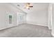 Bright bedroom boasts a ceiling fan, carpeted floors, large windows, and a private patio entrance at 5505 Verbena Creek Ct, Las Vegas, NV 89131