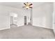 This is a bedroom with neutral carpet, white walls, a ceiling fan, and an ensuite at 5505 Verbena Creek Ct, Las Vegas, NV 89131